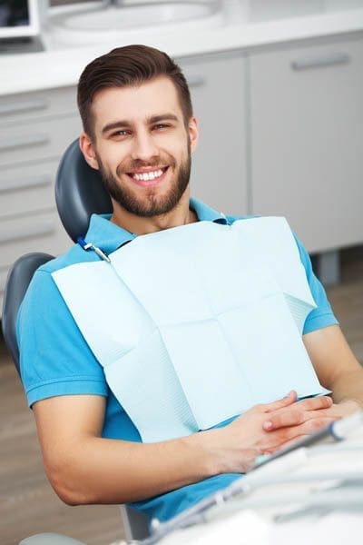 man smiling during his cosmetic dentistry appointment at Derek H. Tang, DDS