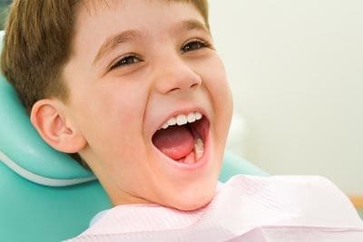 Patient laughing during his pediatric dentist appointment at Derek H. Tang, DDS.